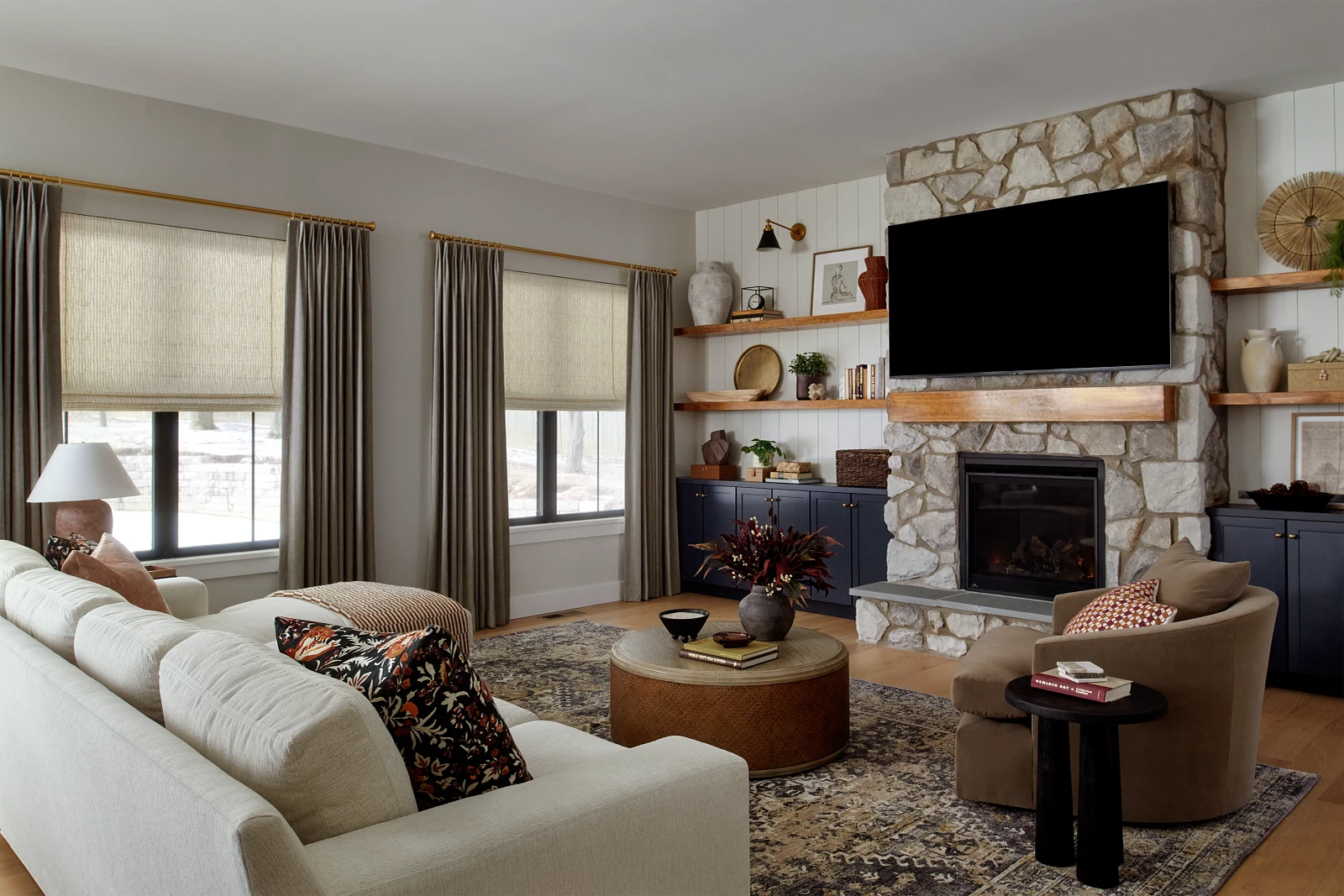 Tailored drapery and Roman shades in a furnished living room