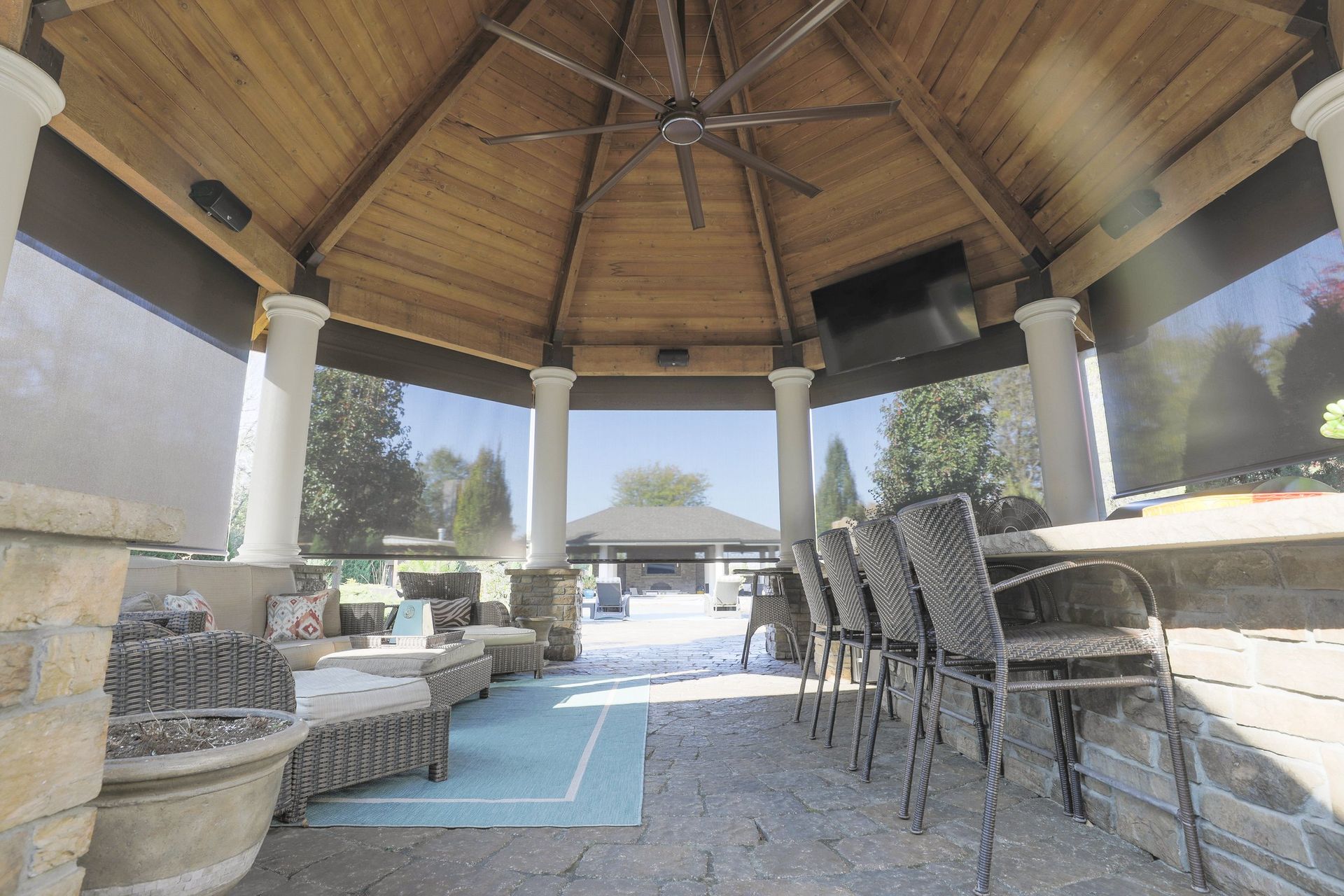 Outdoor pavilion enclosed with exterior roller shades