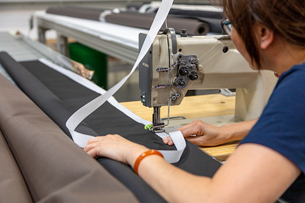 Awning fabric being measured and sewn for replacement