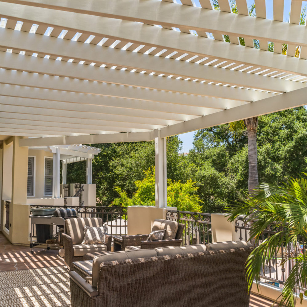 Residential aluminum patio cover creating shaded outdoor living space